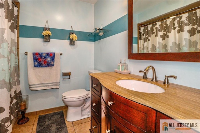 bathroom with vanity, toilet, and tile patterned flooring