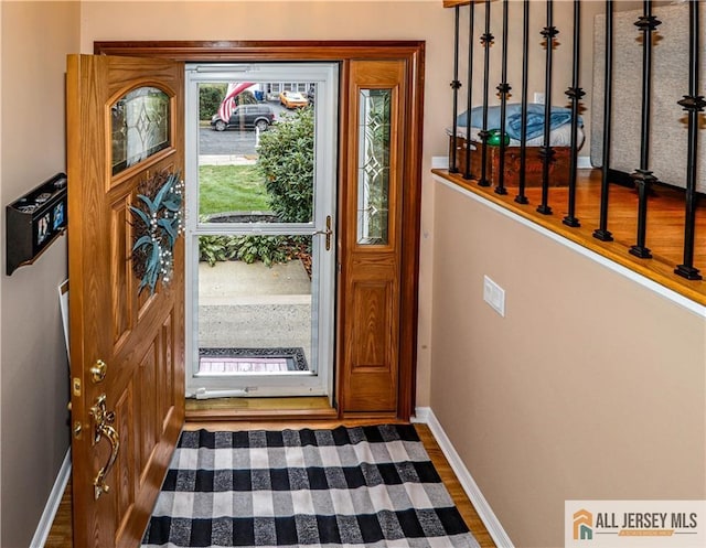 doorway with dark hardwood / wood-style floors