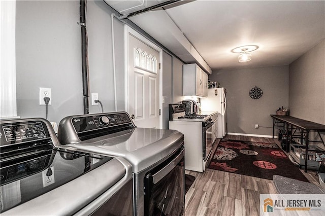 laundry room with hardwood / wood-style flooring and washing machine and dryer