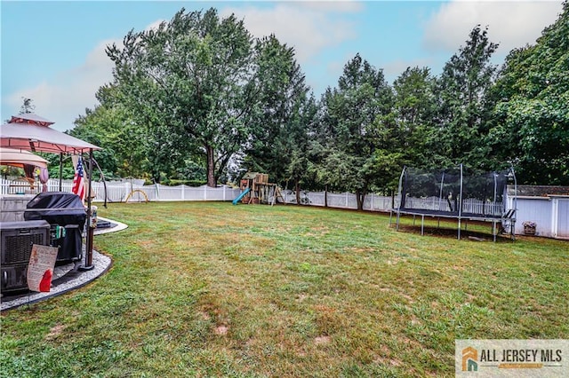 view of yard with a playground, a gazebo, and a trampoline