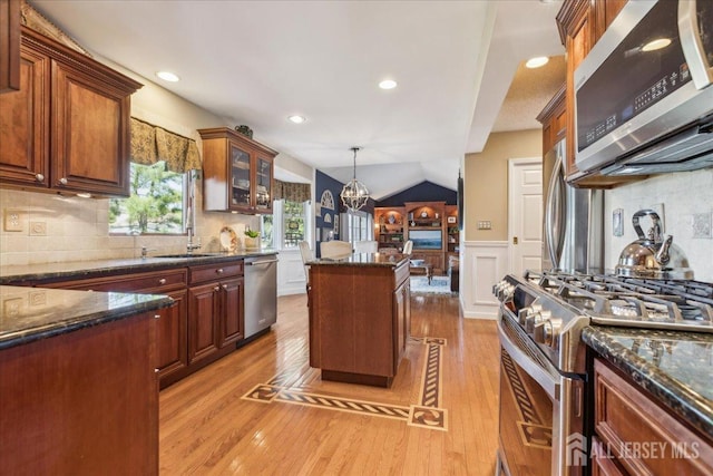 11 Cardinal Ct, Old Bridge, NJ 08857 - kitchen featuring stainless steel appliances, light wood finished floors, a kitchen island, decorative light fixtures, and a wainscoted wall