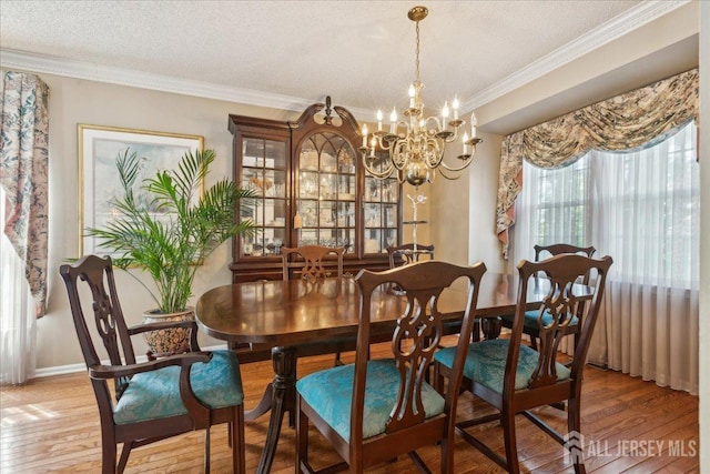11 Cardinal Ct, Old Bridge, NJ 08857 - dining room featuring light wood-style floors, a chandelier, crown molding, a textured ceiling, and baseboards