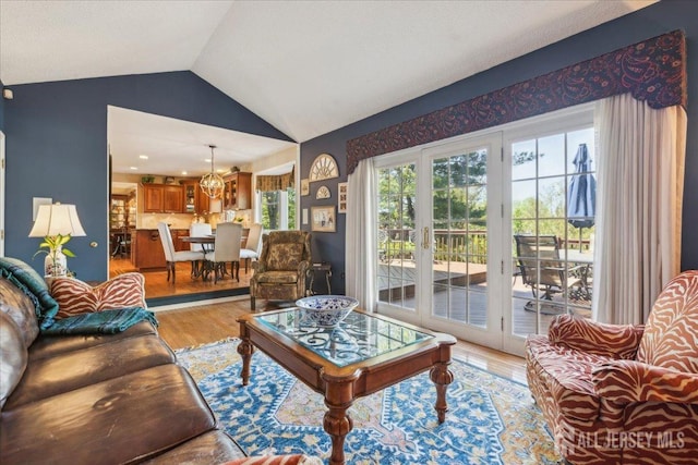 11 Cardinal Ct, Old Bridge, NJ 08857 - living room with light wood-style flooring, vaulted ceiling, and a chandelier