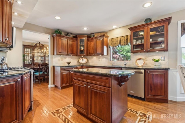 11 Cardinal Ct, Old Bridge, NJ 08857 - kitchen with dishwasher, a sink, gas stove, light wood-type flooring, and glass insert cabinets