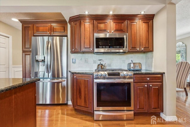 11 Cardinal Ct, Old Bridge, NJ 08857 - kitchen with stainless steel appliances, dark stone countertops, light wood finished floors, decorative backsplash, and recessed lighting