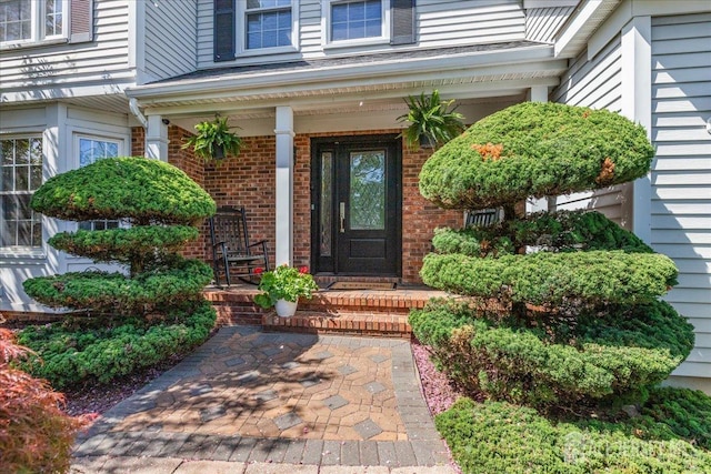 11 Cardinal Ct, Old Bridge, NJ 08857 - view of exterior entry with brick siding and a porch