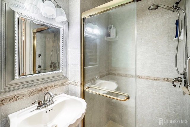 108 Colonia Rd, Colonia, NJ 07067 - bathroom featuring tile walls, a sink, and a stall shower