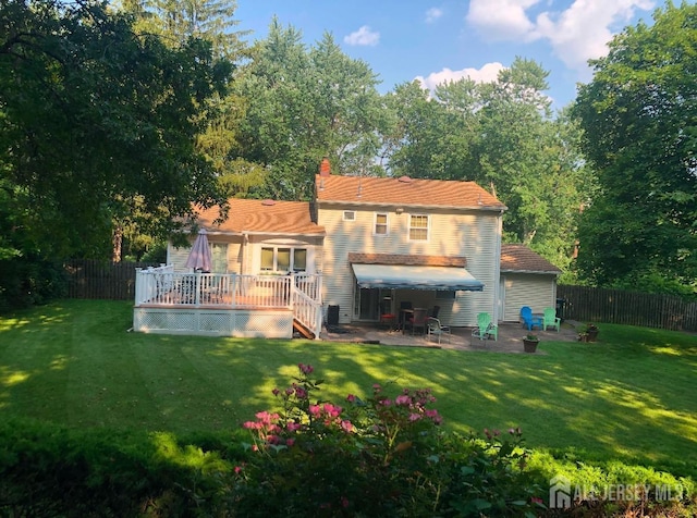 108 Colonia Rd, Colonia, NJ 07067 - rear view of house with a lawn, a patio, a wooden deck, and a fenced backyard
