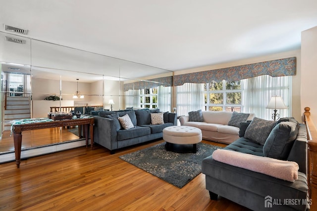108 Colonia Rd, Colonia, NJ 07067 - living room featuring a wealth of natural light, wood finished floors, visible vents, and a baseboard radiator