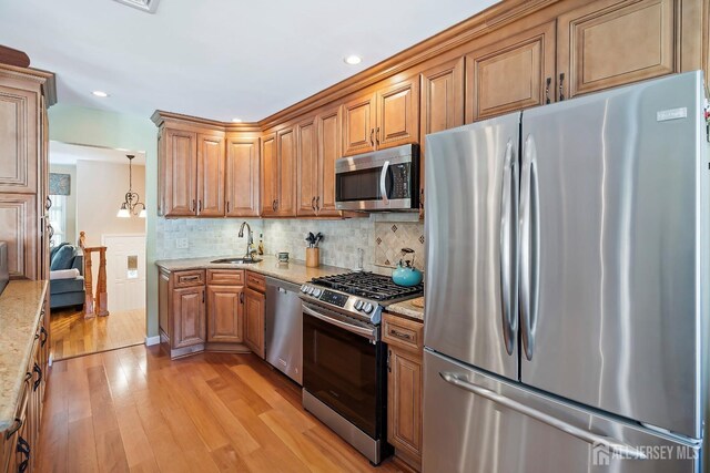 108 Colonia Rd, Colonia, NJ 07067 - kitchen with light stone countertops, stainless steel appliances, light wood finished floors, and a sink