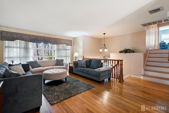 108 Colonia Rd, Colonia, NJ 07067 - living area featuring an inviting chandelier, visible vents, hardwood / wood-style floors, and baseboards