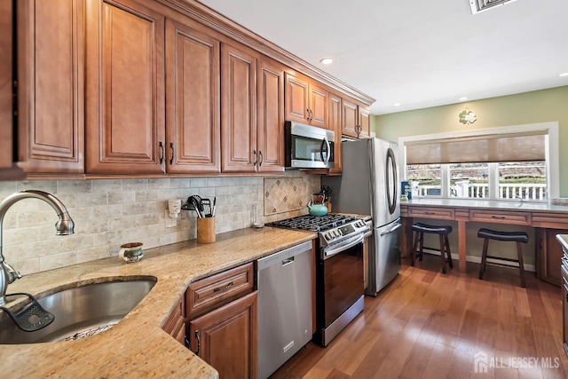 108 Colonia Rd, Colonia, NJ 07067 - kitchen featuring tasteful backsplash, light stone counters, brown cabinetry, stainless steel appliances, and a sink