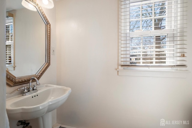 108 Colonia Rd, Colonia, NJ 07067 - bathroom with baseboards, a wealth of natural light, and a sink
