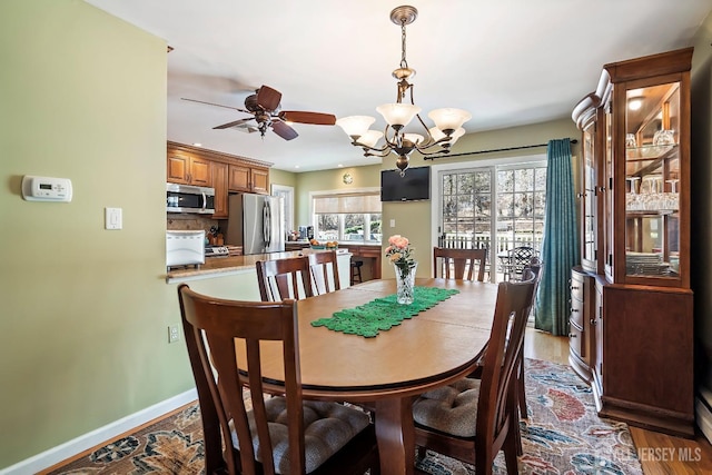 108 Colonia Rd, Colonia, NJ 07067 - dining space featuring wood finished floors, baseboards, and ceiling fan with notable chandelier