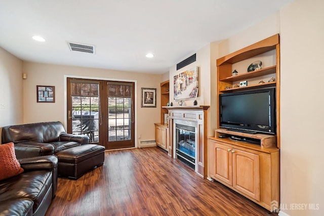 108 Colonia Rd, Colonia, NJ 07067 - living area with visible vents, baseboard heating, a glass covered fireplace, recessed lighting, and dark wood finished floors
