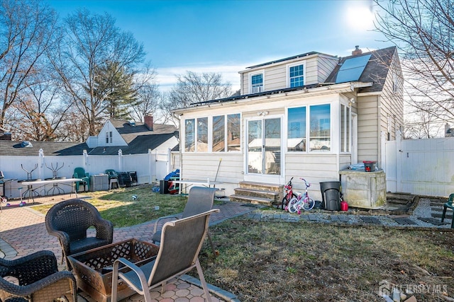 803 W Inman Ave W, Rahway, NJ 07065 - rear view of property featuring a patio, a fenced backyard, entry steps, a chimney, and a sunroom