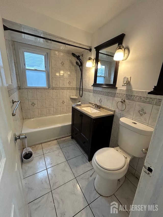 803 W Inman Ave W, Rahway, NJ 07065 - full bathroom featuring tile walls, toilet, marble finish floor, vanity, and shower / washtub combination