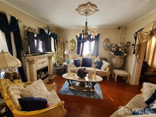 466 W Ave, Sewaren, NJ 07077 - living room featuring a chandelier, ornamental molding, wood finished floors, and a fireplace