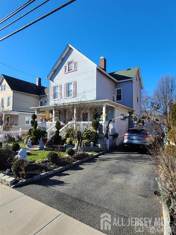 466 W Ave, Sewaren, NJ 07077 - view of front of property with a porch, a chimney, and driveway