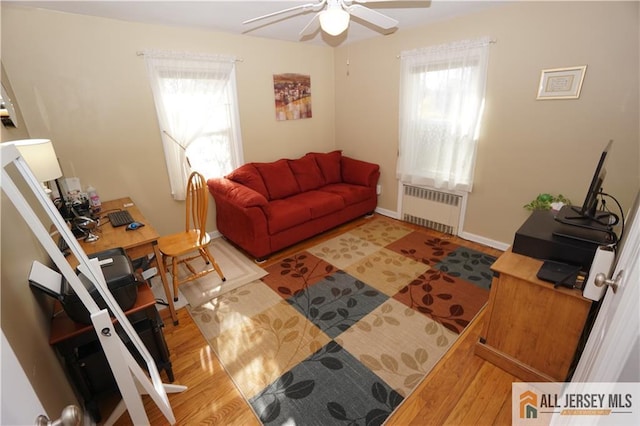 25 Clover Ave, Colonia, NJ 07067 - living room featuring radiator, ceiling fan, healthy amount of natural light, and wood finished floors