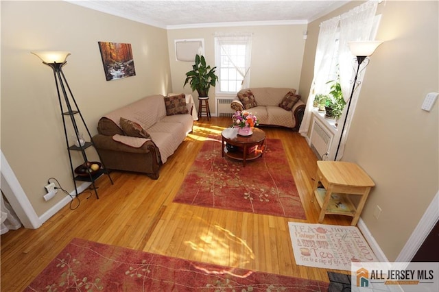 25 Clover Ave, Colonia, NJ 07067 - living area featuring radiator heating unit, wood finished floors, crown molding, and baseboards