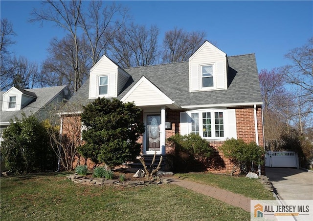 25 Clover Ave, Colonia, NJ 07067 - cape cod house with brick siding, a front yard, and roof with shingles