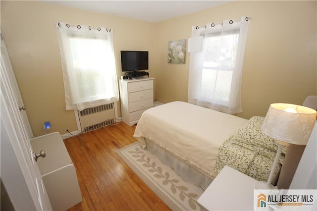 25 Clover Ave, Colonia, NJ 07067 - bedroom featuring radiator heating unit and wood finished floors