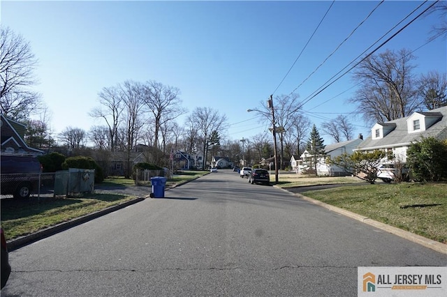 25 Clover Ave, Colonia, NJ 07067 - view of asphalt street featuring curbs, street lighting, and a residential view