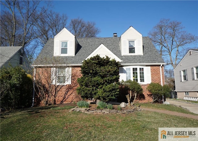 25 Clover Ave, Colonia, NJ 07067 - cape cod home with brick siding, a front lawn, roof with shingles, and a chimney
