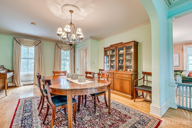 44 Rector St, Metuchen, NJ 08840 - dining area featuring a baseboard radiator, healthy amount of natural light, a chandelier, arched walkways, and crown molding