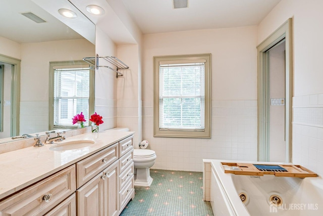 44 Rector St, Metuchen, NJ 08840 - full bathroom with tile walls, a tub with jets, vanity, toilet, and tile patterned floors