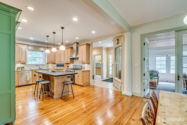 44 Rector St, Metuchen, NJ 08840 - kitchen with appliances with stainless steel finishes, wall chimney range hood, decorative columns, a sink, and ornamental molding