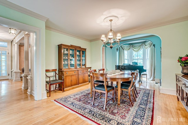 44 Rector St, Metuchen, NJ 08840 - dining space featuring arched walkways, healthy amount of natural light, light wood-style floors, crown molding, and a chandelier