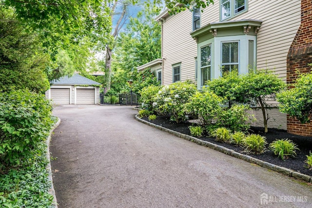 44 Rector St, Metuchen, NJ 08840 - view of side of property featuring a detached garage and an outbuilding