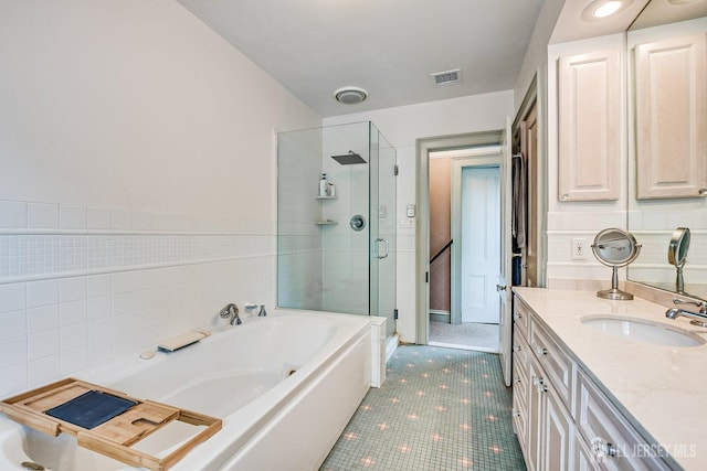 44 Rector St, Metuchen, NJ 08840 - full bath featuring vanity, a garden tub, a shower stall, tile patterned floors, and tile walls