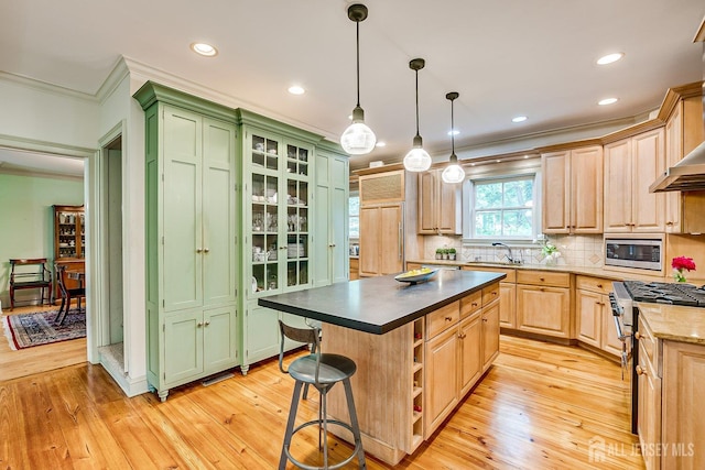 44 Rector St, Metuchen, NJ 08840 - kitchen featuring crown molding, stainless steel microwave, light wood-style flooring, a sink, and tasteful backsplash