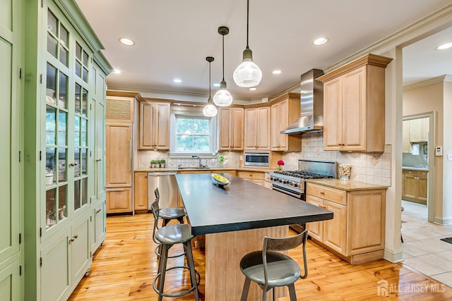 44 Rector St, Metuchen, NJ 08840 - kitchen featuring wall chimney range hood, crown molding, a sink, built in appliances, and a kitchen breakfast bar