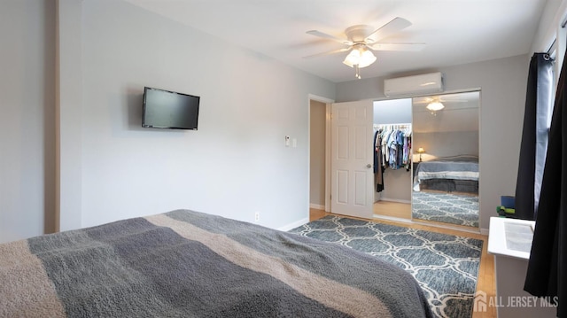 41 Ross Hall Blvd N, Piscataway, NJ 08854 - bedroom featuring a wall mounted air conditioner, wood finished floors, a ceiling fan, baseboards, and a closet