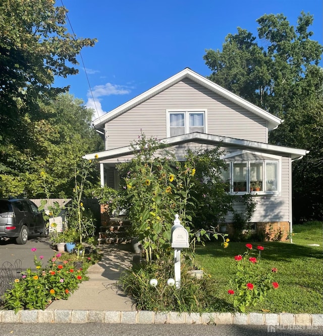 bungalow-style house featuring a front yard