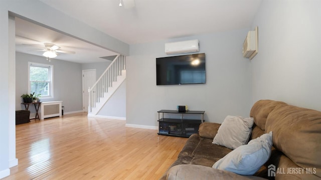 41 Ross Hall Blvd N, Piscataway, NJ 08854 - living room with ceiling fan, a wall mounted AC, stairs, and light wood-type flooring