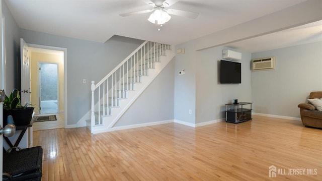 41 Ross Hall Blvd N, Piscataway, NJ 08854 - living area with light wood-type flooring, stairs, ceiling fan, a wall unit AC, and a wall mounted air conditioner