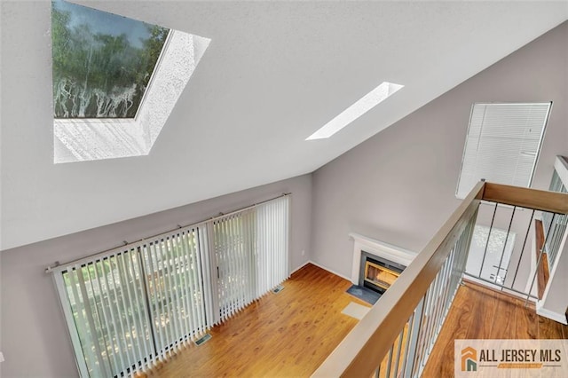 22 Witch Hazel Ct, South Brunswick, NJ 08852 - hall featuring a skylight, wood finished floors, high vaulted ceiling, and an upstairs landing