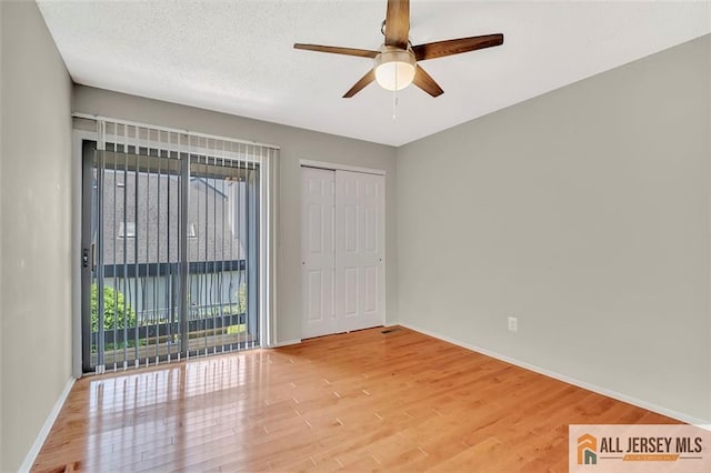 22 Witch Hazel Ct, South Brunswick, NJ 08852 - unfurnished bedroom featuring wood finished floors, access to outside, ceiling fan, and a closet