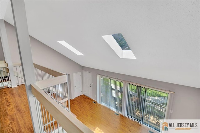 22 Witch Hazel Ct, South Brunswick, NJ 08852 - corridor featuring lofted ceiling, a skylight, and wood finished floors