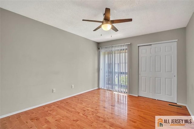 22 Witch Hazel Ct, South Brunswick, NJ 08852 - unfurnished bedroom with wood finished floors, a textured ceiling, ceiling fan, and a closet