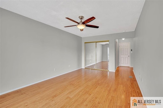 22 Witch Hazel Ct, South Brunswick, NJ 08852 - unfurnished bedroom featuring a closet, light wood-style flooring, ceiling fan, and a textured ceiling