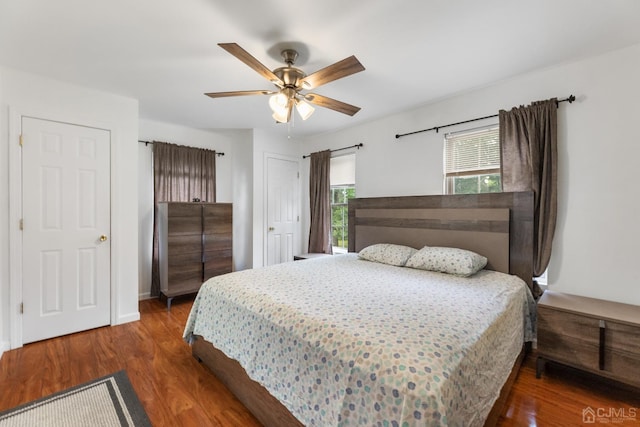 bedroom with wood finished floors, a ceiling fan, and baseboards