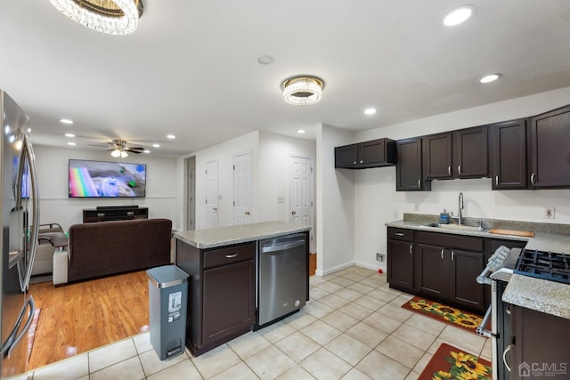 kitchen featuring ceiling fan, sink, stainless steel appliances, light hardwood / wood-style flooring, and dark brown cabinets