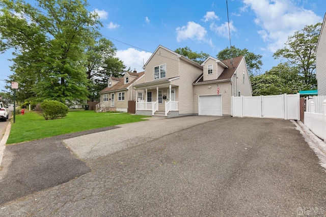 view of front of house with a front lawn, covered porch, and a garage