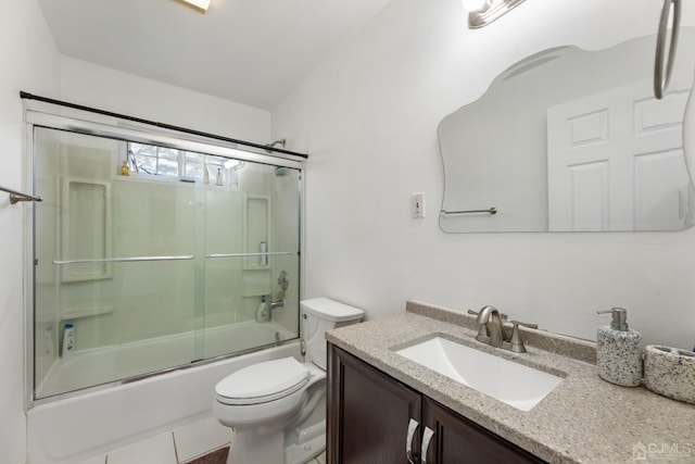 full bathroom featuring vanity, bath / shower combo with glass door, vaulted ceiling, tile patterned flooring, and toilet